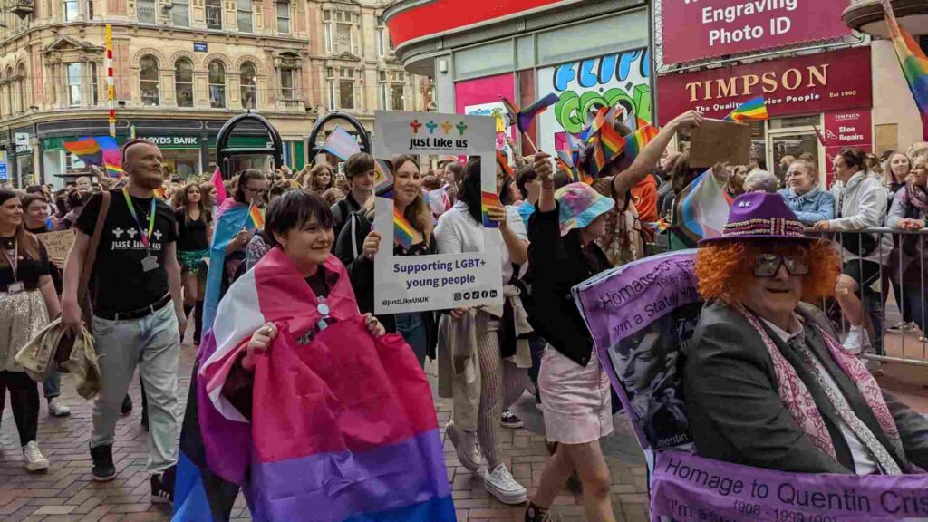 Young people walk with the signs they've made at Birmingham Pride