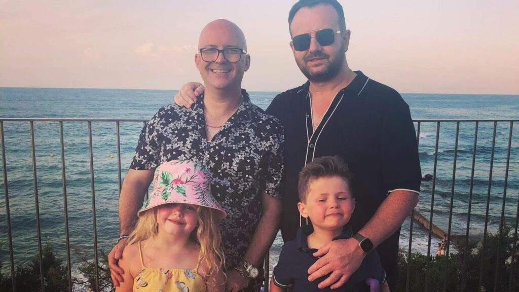 Martin Boyle with his husband and two children.