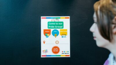 A pupil walks past a Pride Group poster advertising an LGBT+ school club
