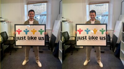 Two side-by-side photos of Jonathan Bailey holding a sign that reads "Just Like Us" and smiling